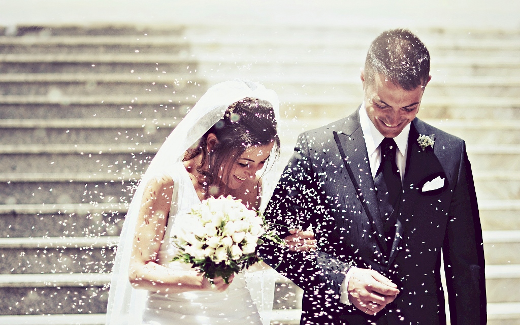 ゲストのみんなにフラワーシャワーで祝福されている新郎新婦