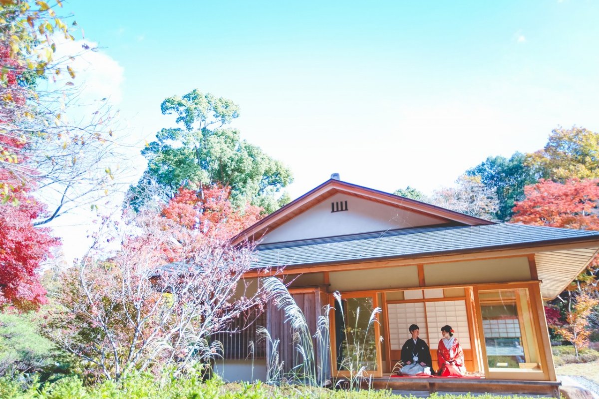 紅葉の彩る青空のもとで結婚写真を。