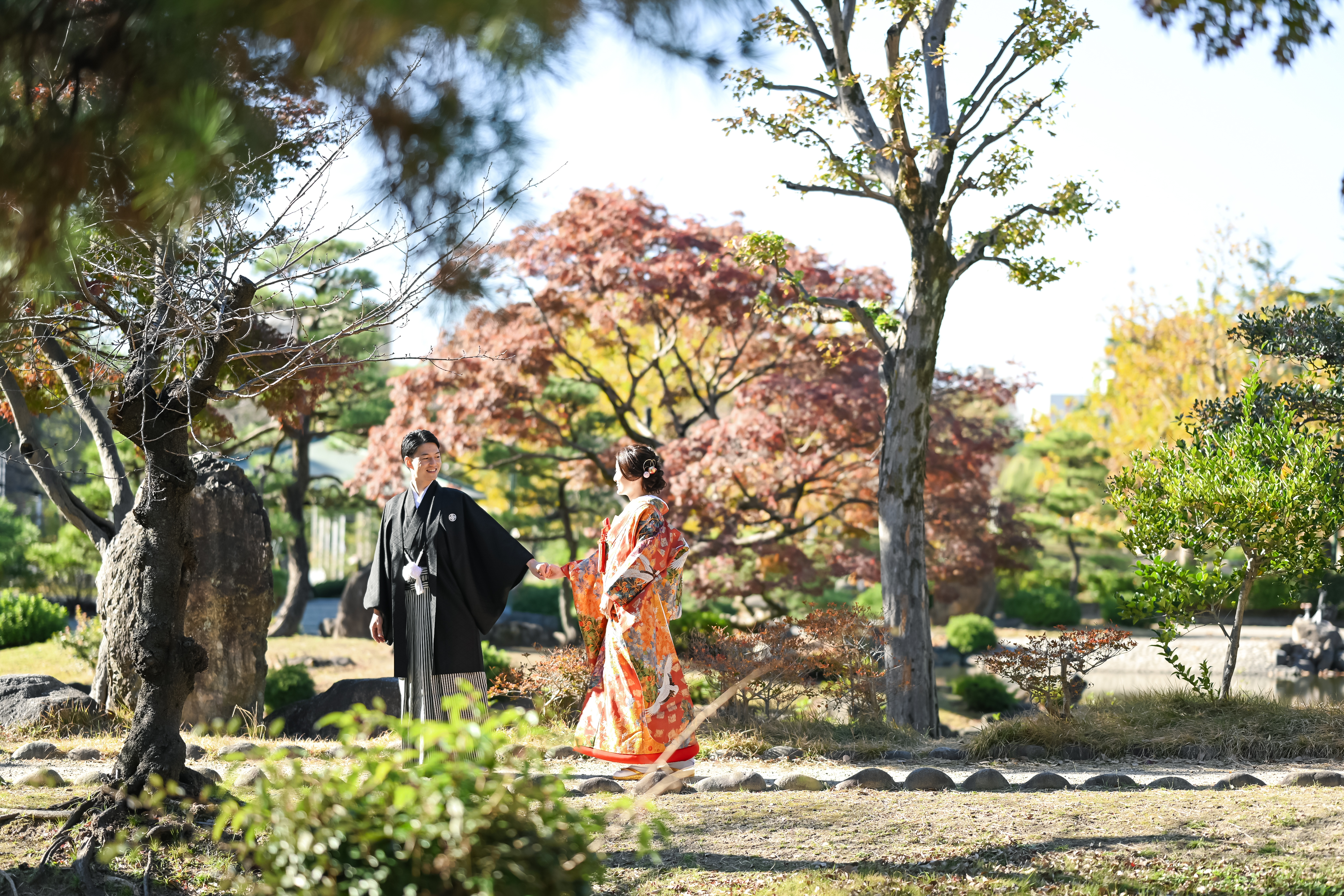 鶴舞公園の紅葉の並木道を歩く前撮りカップル